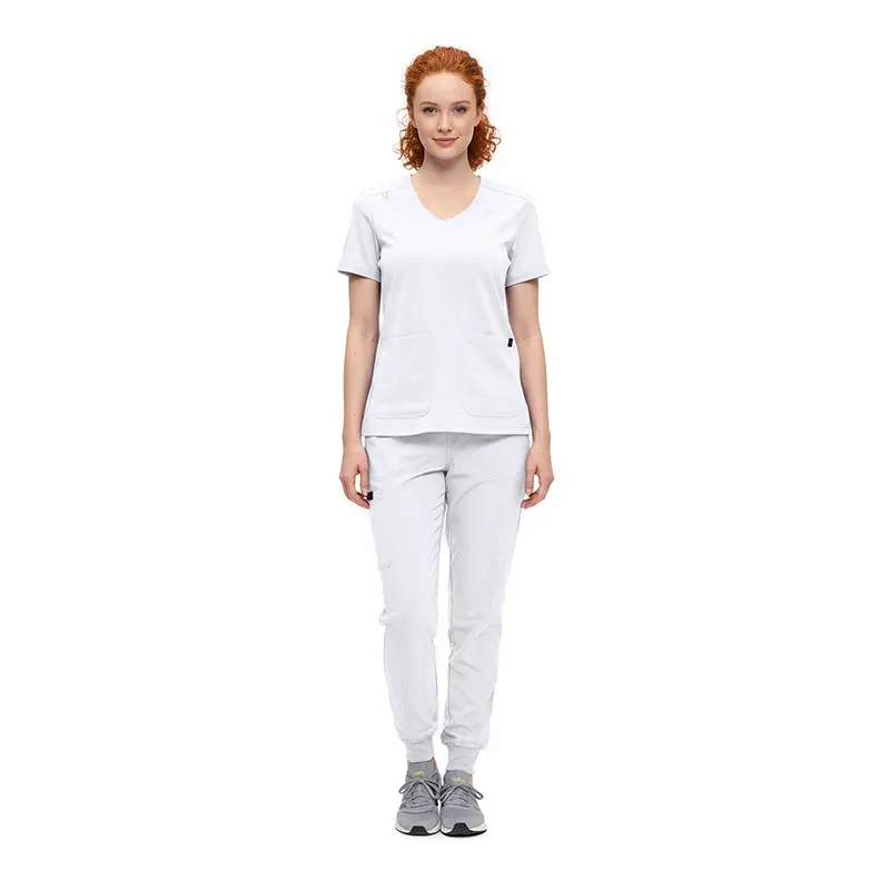 Wholesale women's white v-neck scrub top with short sleeves and front pockets paired with white scrub pants