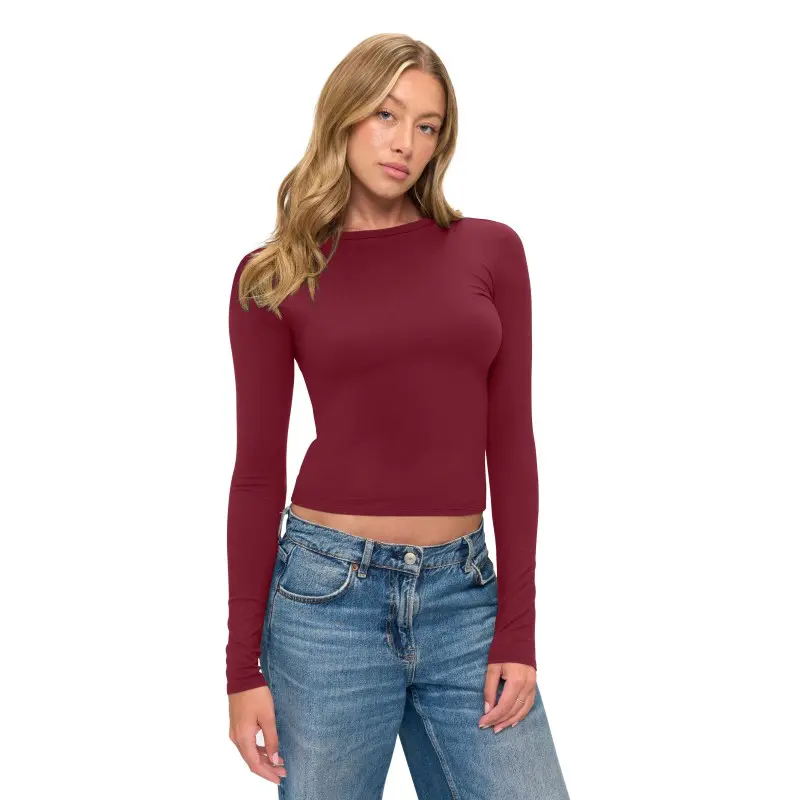 Wholesale women's burgundy long sleeve crop top paired with blue jeans