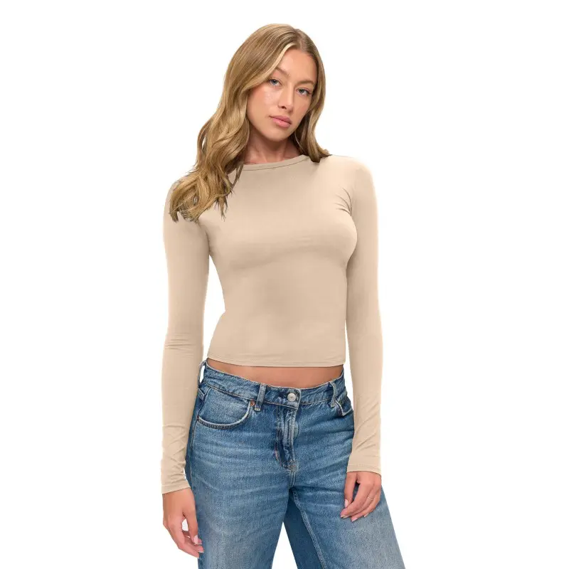 Wholesale women's beige long-sleeve fitted crop top with blue denim jeans