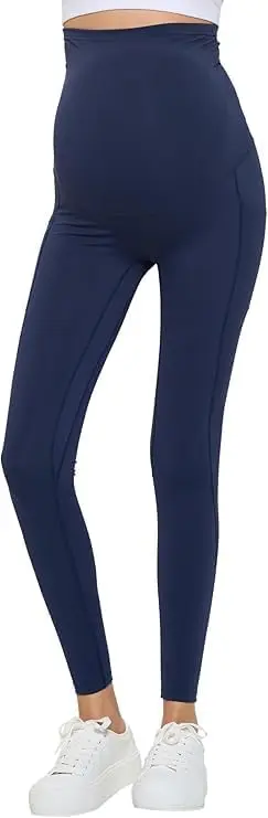 Wholesale navy blue high-waisted leggings with ankle length and stretchy fabric, styled with white sneakers