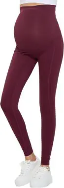 Wholesale women's burgundy maternity leggings with high waistband, paired with white sneakers