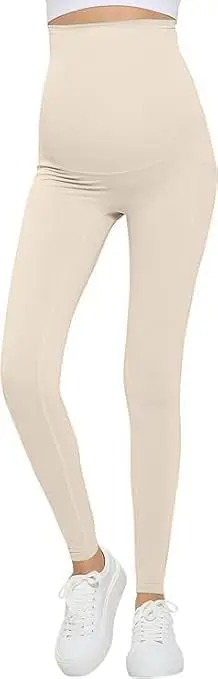 Wholesale beige maternity leggings with ruched side panel and high waistband worn with white sneakers